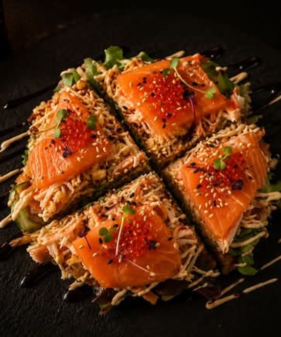 The sushi pizza, topped with salmon and roe