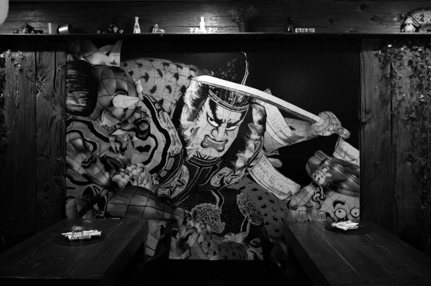 The dining room’s large illustrated mural, in black and white