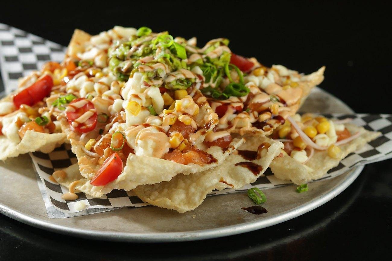 Won ton nachos piled with salmon tartare, corn and cheese curds