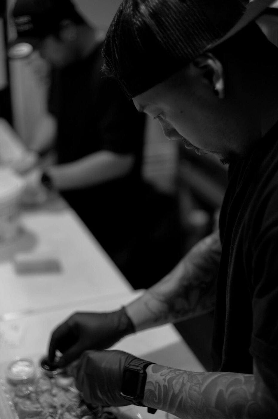 The chef at the counter, plating makis