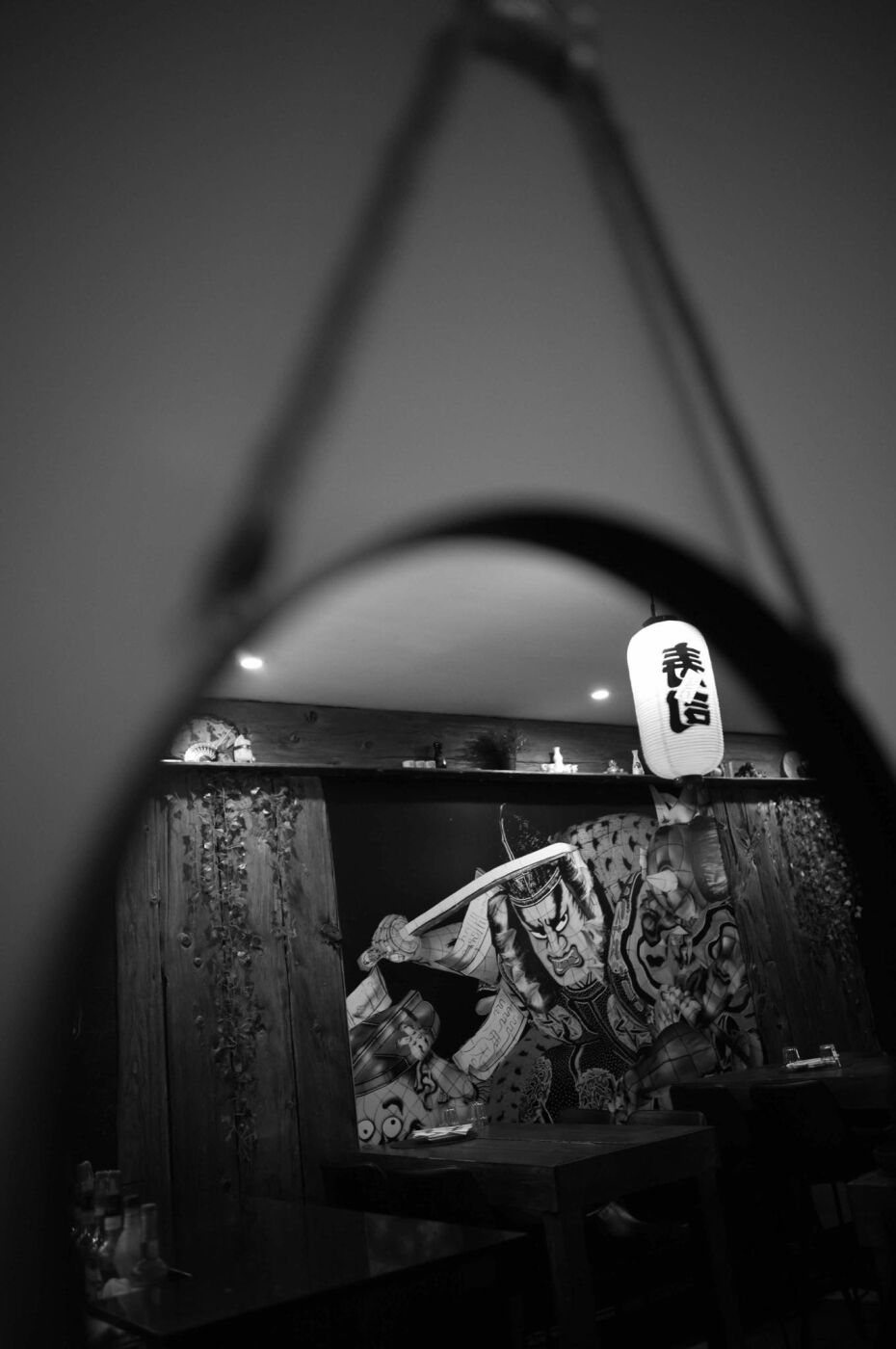 The mural reflected in a round hanging mirror